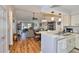 Open-concept living area showcasing wood floors and kitchen bar with abundant natural light at 311 Knottwood Ct, Sun City Center, FL 33573