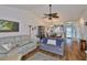 Open-concept living room with vaulted ceilings, hardwood floors, and dining area at 311 Knottwood Ct, Sun City Center, FL 33573