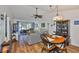 Comfortable living area with hardwood floors, a ceiling fan, and sliding glass doors to a patio at 311 Knottwood Ct, Sun City Center, FL 33573