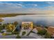 Expansive waterfront property featuring a luxury home with manicured grounds and direct access to the tranquil bay waters at 3236 Gulf Winds Cir, Hernando Beach, FL 34607