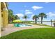 Enjoy the serene backyard with a refreshing pool, lush landscaping, and picturesque water views, perfect for relaxation at 3236 Gulf Winds Cir, Hernando Beach, FL 34607