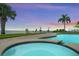 Lush backyard with a sparkling spa and views of the water, creating a private oasis for relaxation and enjoyment at 3236 Gulf Winds Cir, Hernando Beach, FL 34607