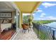 This balcony features beautiful views of the water, wicker seating, and has access to the main bedroom at 3236 Gulf Winds Cir, Hernando Beach, FL 34607