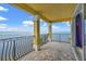 Covered balcony with wrought iron railing showcasing expansive water views at 3236 Gulf Winds Cir, Hernando Beach, FL 34607