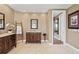 Elegant bathroom featuring dual vanities, a decorative ladder, and neutral color palette at 3236 Gulf Winds Cir, Hernando Beach, FL 34607