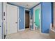 Bright bathroom showcasing an ensuite, shower, and commode room with blue and green paint at 3236 Gulf Winds Cir, Hernando Beach, FL 34607