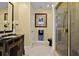 Elegant bathroom featuring a glass shower, ornate vanity, and neutral tiling for a relaxing atmosphere at 3236 Gulf Winds Cir, Hernando Beach, FL 34607