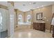 This bathroom features two large columns, a soaking tub, neutral paint, and white tiling at 3236 Gulf Winds Cir, Hernando Beach, FL 34607
