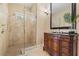 Elegant bathroom with a glass-enclosed shower and an ornate wooden vanity with granite countertop at 3236 Gulf Winds Cir, Hernando Beach, FL 34607