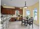 Breakfast nook area with custom cabinets, a work station, and serene outdoor views at 3236 Gulf Winds Cir, Hernando Beach, FL 34607