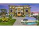 Stunning multi-story home showcasing unique architectural details, pristine landscaping, and a private pool with water views at 3236 Gulf Winds Cir, Hernando Beach, FL 34607