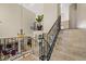 Spacious foyer featuring a decorative staircase, high ceilings, and views of the living and dining areas below at 3236 Gulf Winds Cir, Hernando Beach, FL 34607