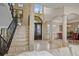 Spacious foyer featuring a staircase, travertine floors, and decorative columns throughout at 3236 Gulf Winds Cir, Hernando Beach, FL 34607