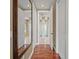 This hallway features hardwood floors, neutral paint, and an elongated mirror that leads to the bathroom at 3236 Gulf Winds Cir, Hernando Beach, FL 34607