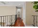 Hallway with hardwood floors, decorative iron railings, and archway at 3236 Gulf Winds Cir, Hernando Beach, FL 34607