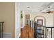 Hallway with hardwood floors, iron railings, archway, and lots of natural light at 3236 Gulf Winds Cir, Hernando Beach, FL 34607