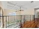 Hallway with decorative railing overlooking the lower level, recessed lighting, and large windows for natural light at 3236 Gulf Winds Cir, Hernando Beach, FL 34607