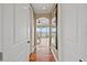 This hallway features hardwood floors, neutral paint, and has views of the water and balcony at the end at 3236 Gulf Winds Cir, Hernando Beach, FL 34607