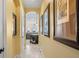 Hallway with arched doorway and pictures on the wall, that leads to the kitchen at 3236 Gulf Winds Cir, Hernando Beach, FL 34607