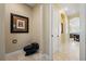 Hallway with a unique black toilet and travertine floors, leading to other rooms in the house at 3236 Gulf Winds Cir, Hernando Beach, FL 34607