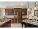 Open kitchen with custom cabinets, granite counters, and stainless steel refrigerator at 3236 Gulf Winds Cir, Hernando Beach, FL 34607