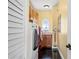 Bright laundry room with modern washer and dryer, ample storage, and sleek tile flooring at 3236 Gulf Winds Cir, Hernando Beach, FL 34607