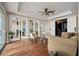 Bright living room with hardwood floors, stylish furniture, and glass doors that lead to other rooms at 3236 Gulf Winds Cir, Hernando Beach, FL 34607