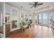 An open concept living room with hardwood floors, stylish chairs, and plenty of natural light coming from French doors at 3236 Gulf Winds Cir, Hernando Beach, FL 34607