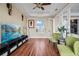 Bright living room features hardwood floors, modern decor, and a large window that provides ample natural light at 3236 Gulf Winds Cir, Hernando Beach, FL 34607