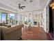 Bright living room with hardwood floors, stylish furniture, and glass doors with access to the balcony and other rooms at 3236 Gulf Winds Cir, Hernando Beach, FL 34607