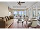 Bright living room with hardwood floors, stylish furniture, and sliding doors to a balcony overlooking the lake at 3236 Gulf Winds Cir, Hernando Beach, FL 34607