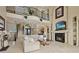 Elegant living room boasting high ceilings, a cozy fireplace, and an open floor plan ideal for entertaining and relaxation at 3236 Gulf Winds Cir, Hernando Beach, FL 34607