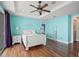 Charming bedroom with wooden floors, ceiling fan, slider to a balcony and ensuite access at 3236 Gulf Winds Cir, Hernando Beach, FL 34607