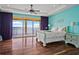 Spacious bedroom boasts wood floors, tray ceiling, and a private balcony with water views at 3236 Gulf Winds Cir, Hernando Beach, FL 34607