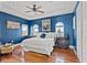 Sophisticated bedroom featuring hardwood floors and bright blue painted walls at 3236 Gulf Winds Cir, Hernando Beach, FL 34607