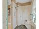 This shower features glass doors, decorative tiling, a shower head, and a bench on the corner at 3236 Gulf Winds Cir, Hernando Beach, FL 34607