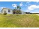 View of the rear of the home, screened patio and lush lawn at 33700 Hamilton Hill Ln, Wesley Chapel, FL 33545