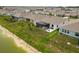 A view of a home's backyard that features a screened in patio and a lake at 33700 Hamilton Hill Ln, Wesley Chapel, FL 33545