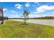 The lush backyard leads to the serene lake, enhancing the beauty of the outdoor space at 33700 Hamilton Hill Ln, Wesley Chapel, FL 33545