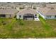 Aerial view of backyard with a black screened-in patio at 33700 Hamilton Hill Ln, Wesley Chapel, FL 33545