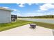 Spacious backyard with a fire pit, situated near the serene lake, offers tranquility and relaxation at 33700 Hamilton Hill Ln, Wesley Chapel, FL 33545