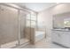 Bright bathroom with a glass-enclosed shower, soaking tub, and vanity with granite countertops at 33700 Hamilton Hill Ln, Wesley Chapel, FL 33545