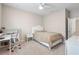 Cozy bedroom featuring neutral walls, carpet, ceiling fan and a comfy bed for relaxing at 33700 Hamilton Hill Ln, Wesley Chapel, FL 33545