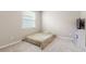 Neutral bedroom with a bed on the floor and a cube shelf with television at 33700 Hamilton Hill Ln, Wesley Chapel, FL 33545