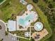 Overhead view of the community pool featuring a kiddie splash area, playground, clubhouse, and a large pool at 33700 Hamilton Hill Ln, Wesley Chapel, FL 33545