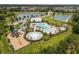 Beautiful community pool area with kiddie splash area, playground, and clubhouse nestled amongst mature trees at 33700 Hamilton Hill Ln, Wesley Chapel, FL 33545