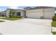 Long driveway leading to a well-maintained home with a three-car garage at 33700 Hamilton Hill Ln, Wesley Chapel, FL 33545
