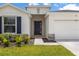 Welcoming front entrance with stone accents and a manicured lawn at 33700 Hamilton Hill Ln, Wesley Chapel, FL 33545