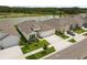 Beautiful single-Gathering home with a two-car garage, lush lawn, and view of community lake at 33700 Hamilton Hill Ln, Wesley Chapel, FL 33545