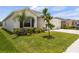 Well-maintained front yard with lush landscaping and a charming home at 33700 Hamilton Hill Ln, Wesley Chapel, FL 33545